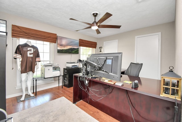 home office with hardwood / wood-style flooring, ceiling fan, a healthy amount of sunlight, and a textured ceiling