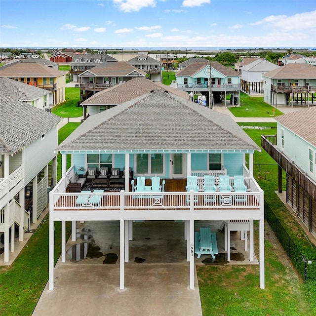 back of property featuring a wooden deck, a carport, and a balcony