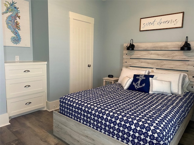 bedroom with dark hardwood / wood-style flooring