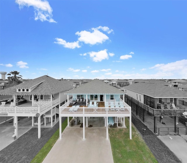 view of front of home featuring a front lawn, a carport, a balcony, and a deck