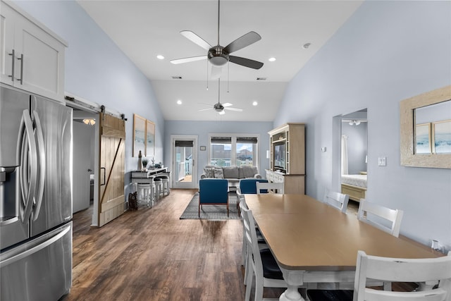 dining area featuring dark wood finished floors, a barn door, recessed lighting, ceiling fan, and high vaulted ceiling