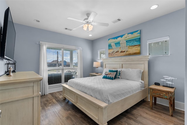 bedroom featuring dark wood-type flooring, visible vents, and ceiling fan