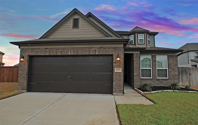 view of front of property with a yard and a garage