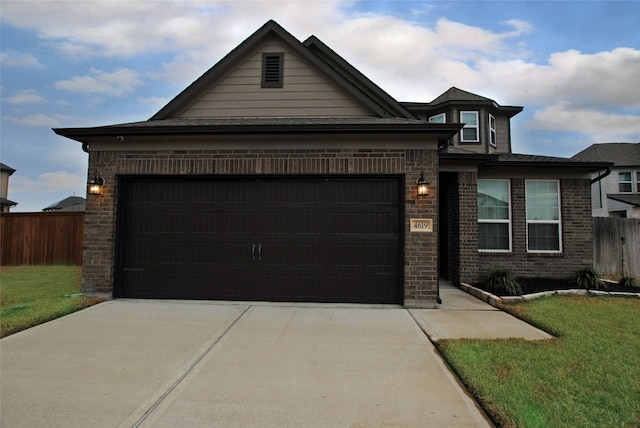 view of front of property with a garage and a front lawn