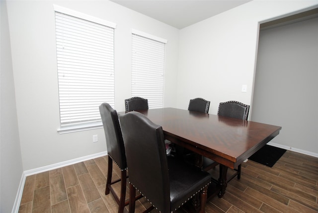 dining area featuring dark wood-type flooring