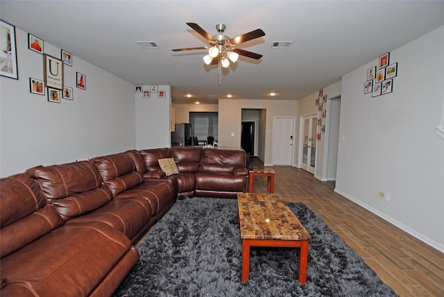 living room with hardwood / wood-style floors and ceiling fan