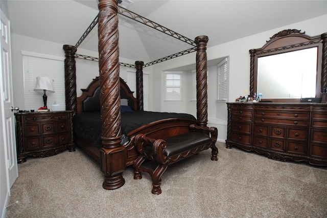 carpeted bedroom featuring vaulted ceiling