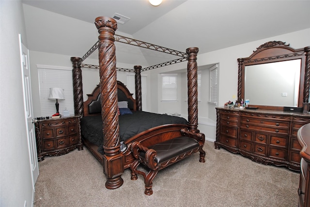 bedroom with lofted ceiling and carpet floors