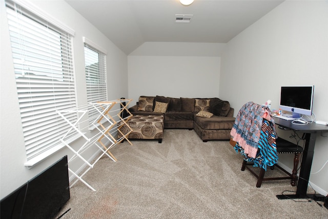 carpeted living room featuring lofted ceiling