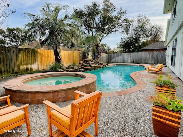 view of swimming pool featuring an in ground hot tub