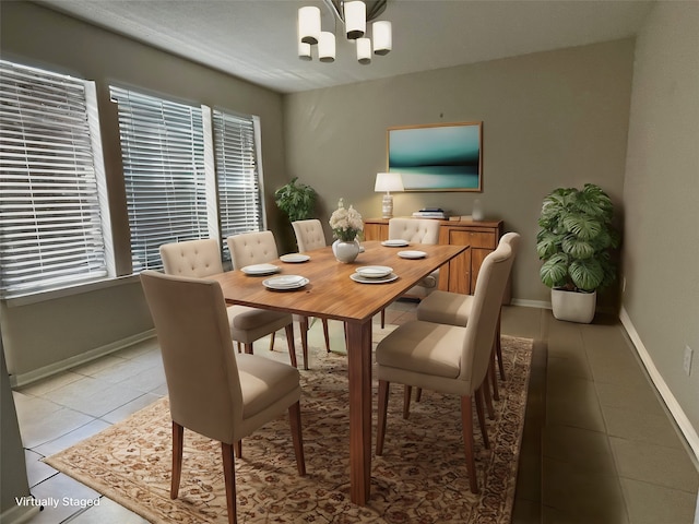 dining space with a chandelier and light tile patterned floors