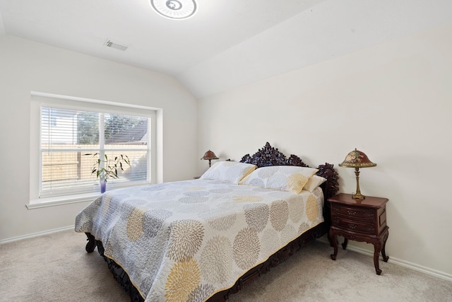 carpeted bedroom with lofted ceiling