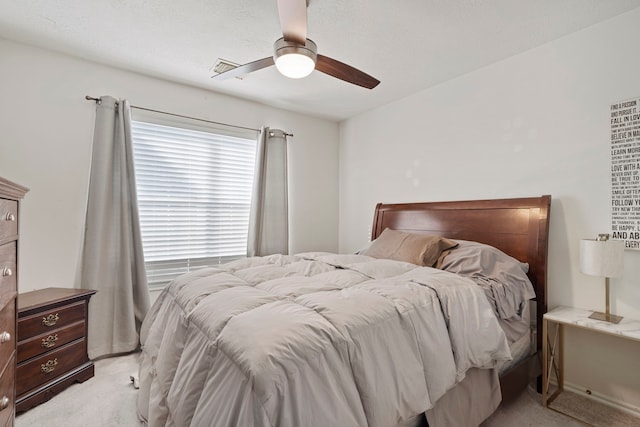 bedroom featuring light carpet and ceiling fan