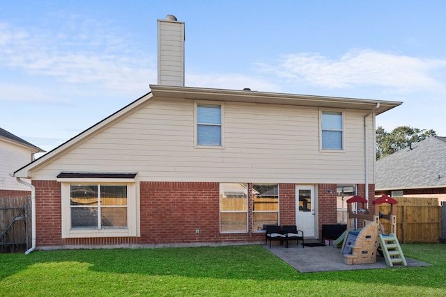 rear view of house featuring a patio, a playground, and a lawn