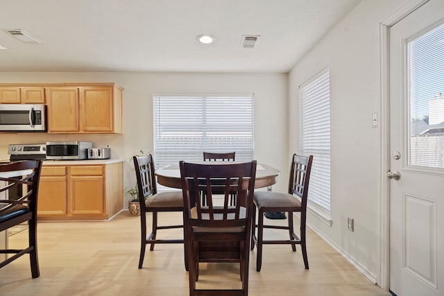 dining space featuring light wood-type flooring