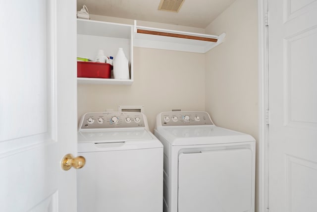 clothes washing area with washer and dryer