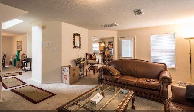 carpeted living room with a textured ceiling