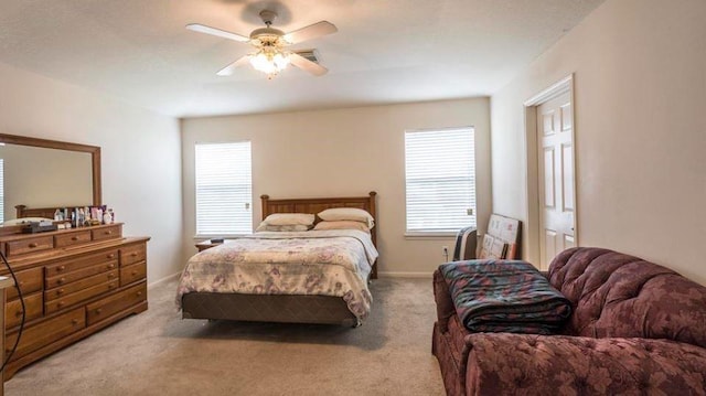 bedroom with light carpet and ceiling fan