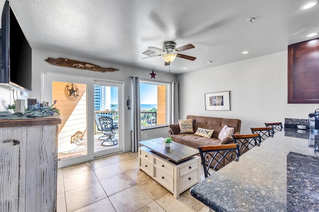 9520 Seawall Blvd Unit 354, Galveston, TX 77554 - living room featuring a ceiling fan, recessed lighting, a textured ceiling, and light tile patterned floors