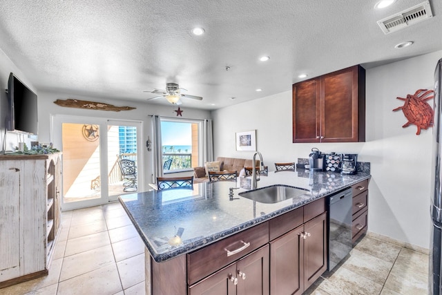 9520 Seawall Blvd Unit 354, Galveston, TX 77554 - kitchen with a sink, dishwashing machine, a peninsula, dark stone counters, and baseboards