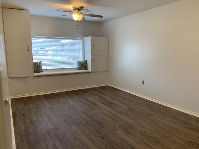 unfurnished room with dark hardwood / wood-style floors and ceiling fan