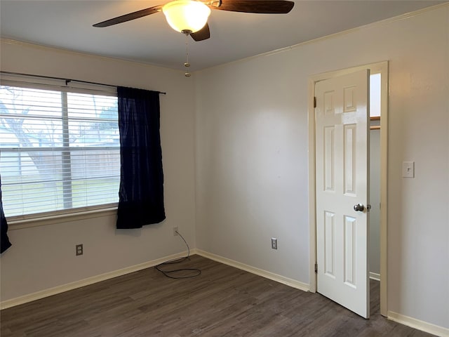 unfurnished room with dark hardwood / wood-style flooring, crown molding, and ceiling fan