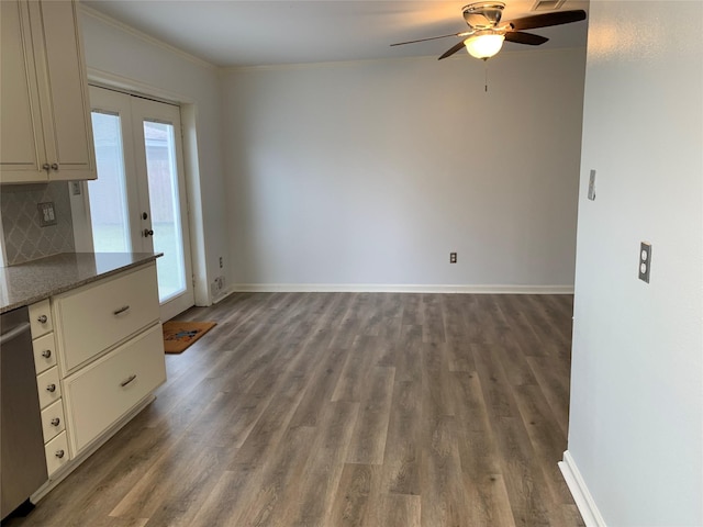 unfurnished dining area featuring crown molding, hardwood / wood-style floors, ceiling fan, and french doors