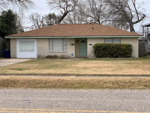 ranch-style house featuring a garage and a front lawn