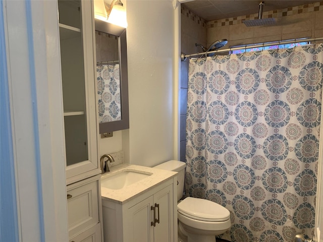 bathroom featuring vanity, toilet, and walk in shower