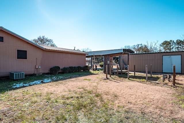 view of yard with an outbuilding and central air condition unit