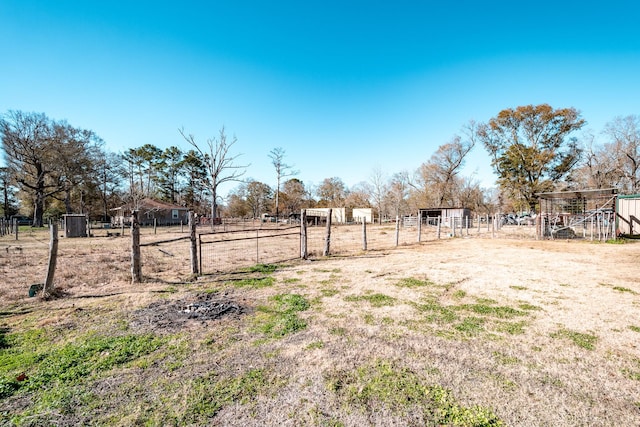 view of yard with a rural view and an outbuilding