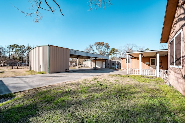 view of yard with a garage and an outbuilding