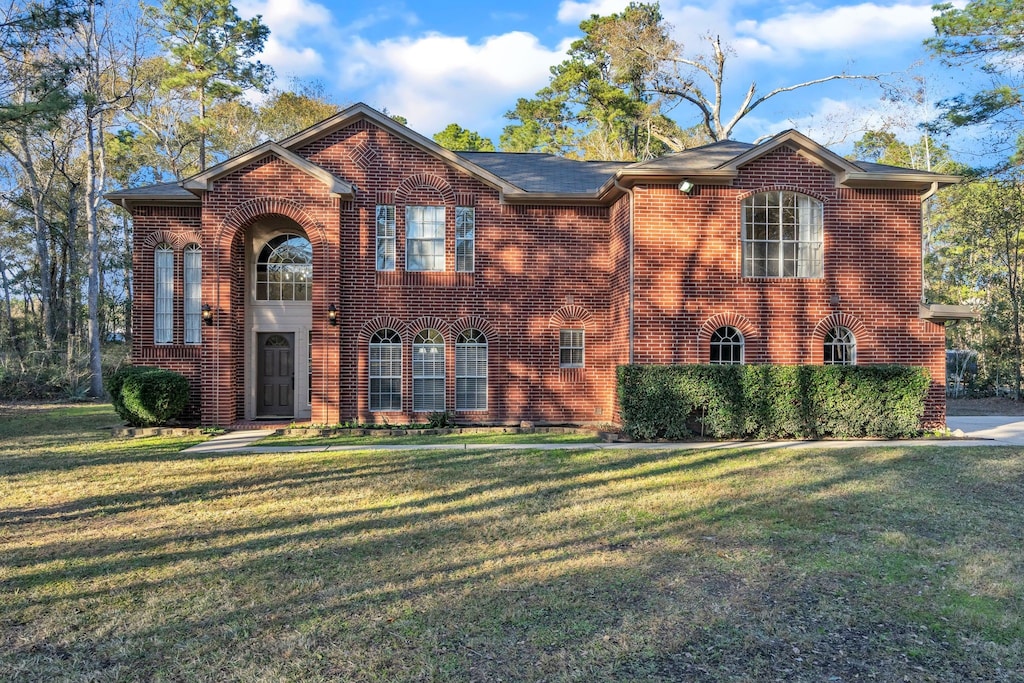 11871 Elizabeth Rdg, Conroe, TX 77304 - view of front of house with a front yard