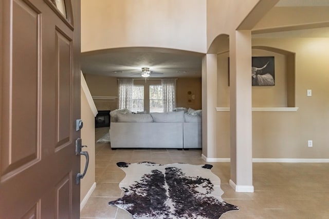 entrance foyer featuring ceiling fan and light tile patterned floors