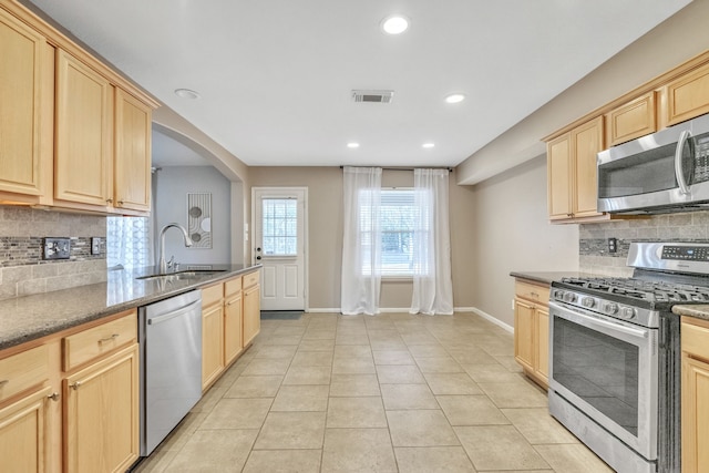 kitchen featuring tasteful backsplash, stainless steel appliances, sink, and light brown cabinets