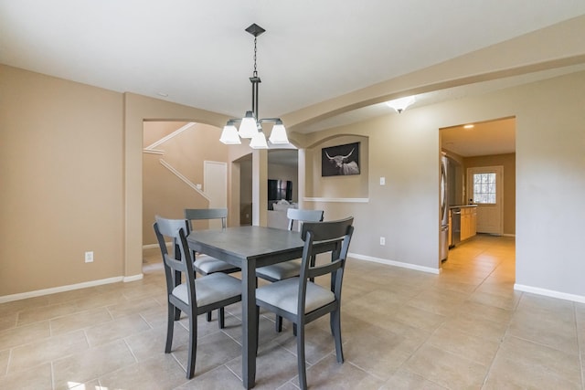 dining room with a notable chandelier and light tile patterned flooring