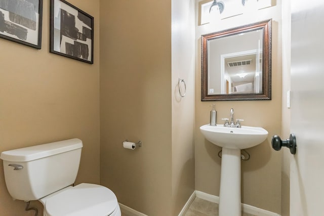 bathroom with tile patterned floors and toilet