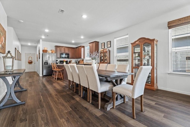 dining space with dark hardwood / wood-style floors