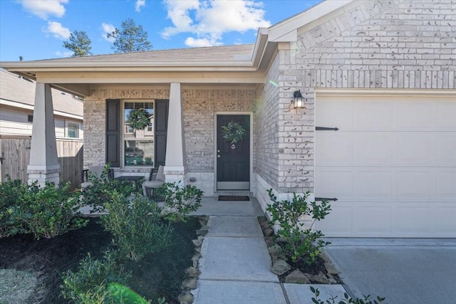 property entrance featuring a garage and covered porch