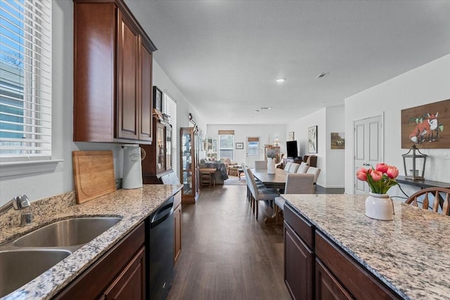 kitchen with dark brown cabinets, black dishwasher, sink, and light stone counters