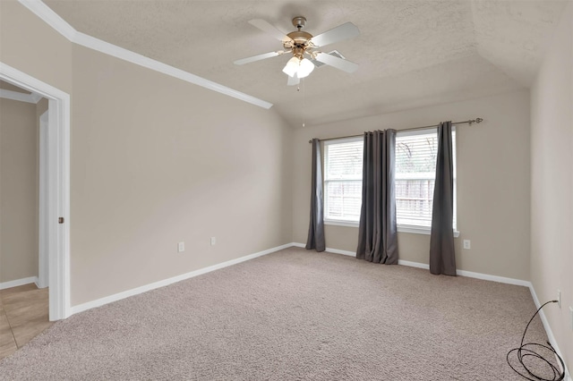 carpeted spare room with vaulted ceiling, ceiling fan, and a textured ceiling