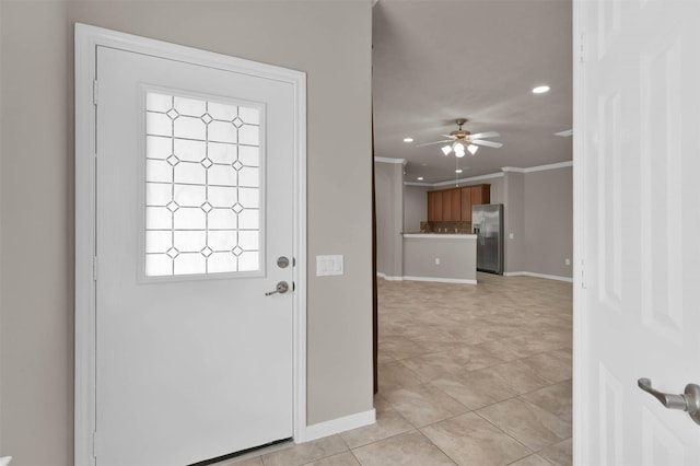 entryway featuring ornamental molding, ceiling fan, and light tile patterned flooring