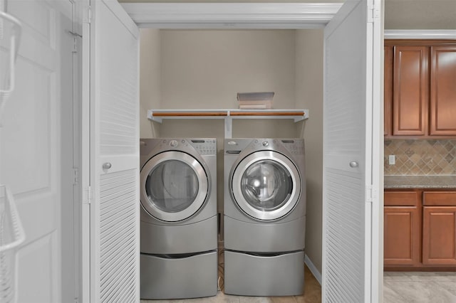 washroom with separate washer and dryer and light tile patterned floors