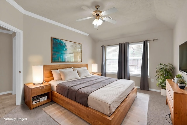 bedroom featuring vaulted ceiling, ornamental molding, light carpet, and ceiling fan