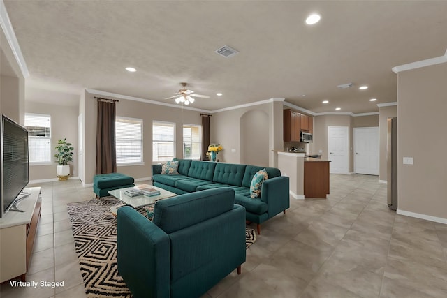 living room featuring ornamental molding, a healthy amount of sunlight, light tile patterned floors, and ceiling fan