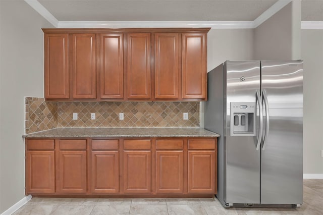 kitchen featuring ornamental molding, light stone countertops, and stainless steel fridge with ice dispenser