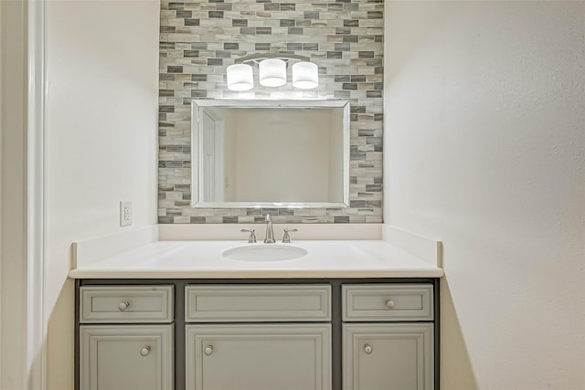 bathroom featuring vanity and decorative backsplash