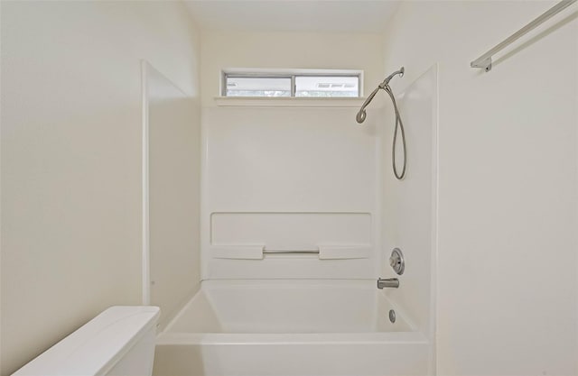 bathroom featuring shower / bathtub combination and toilet