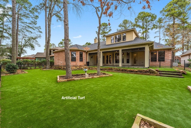 back of house with a patio and a lawn