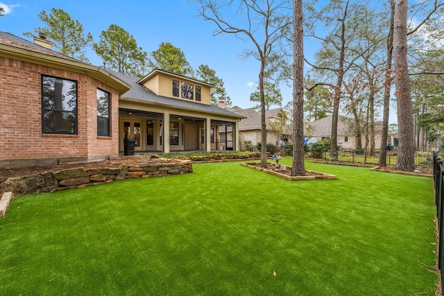 rear view of house with a yard